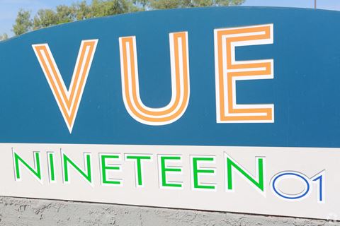a sign for vue nintendo in front of a tree