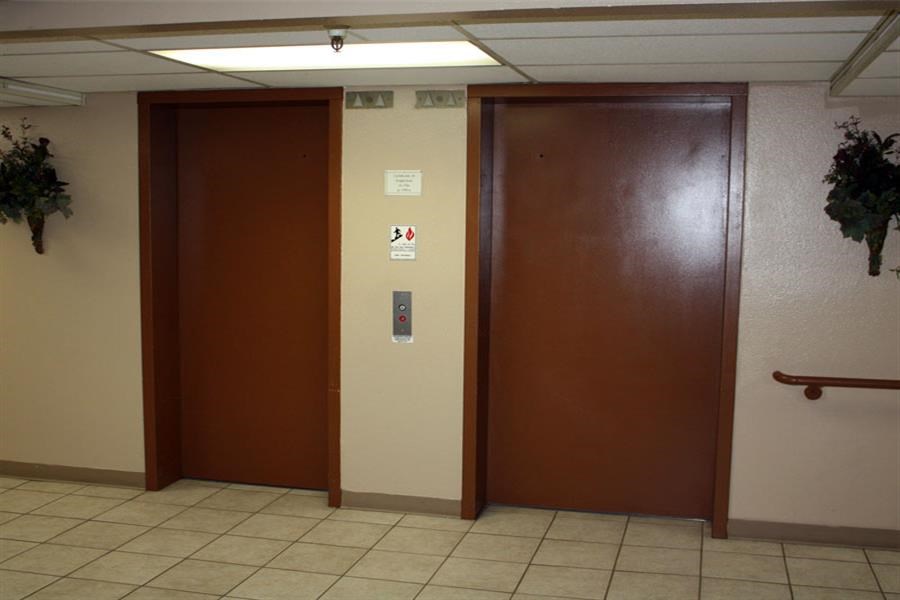 two elevators in a hallway of a building
