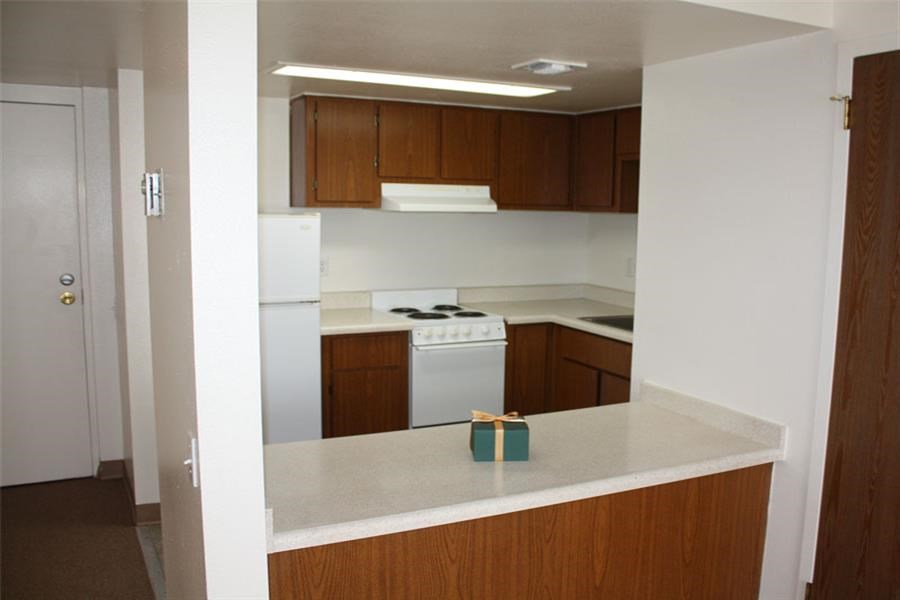 an empty kitchen with a gift on the counter