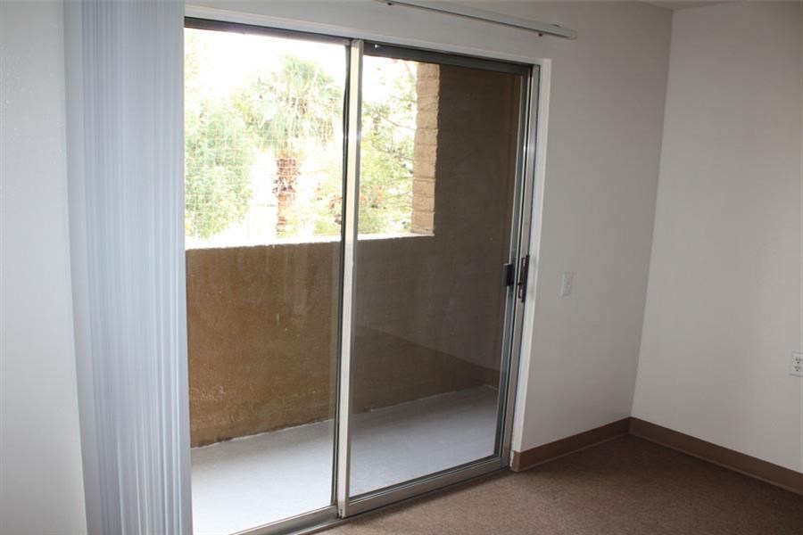 a room with a sliding glass door and a window