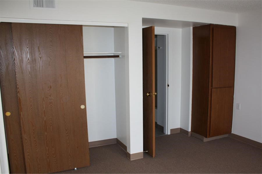 a room with a closet and two doors in it