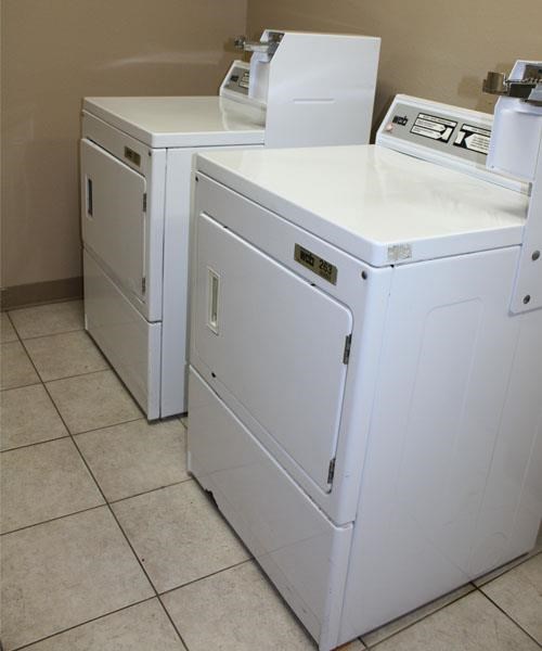 two white appliances sitting next to each other in a kitchen