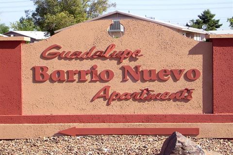 a sign for a bario nuevo apartments in front of a building