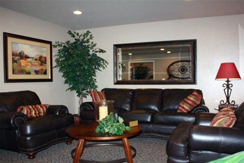 a living room with leather couches and a table