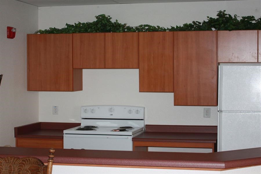 a kitchen with a white stove and wooden cabinets