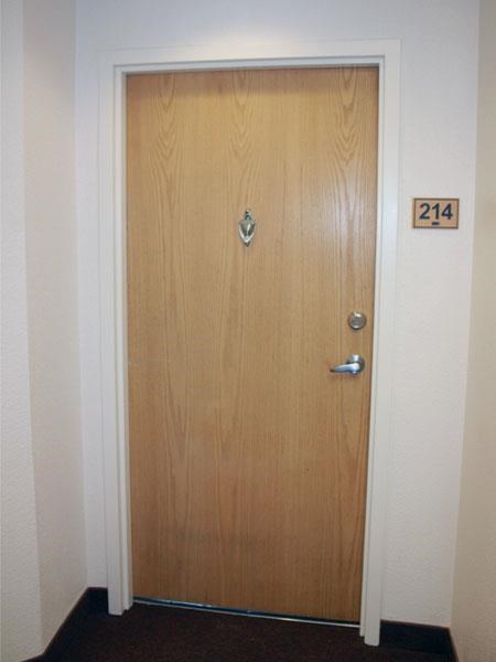 a wooden door with a number on the side of it