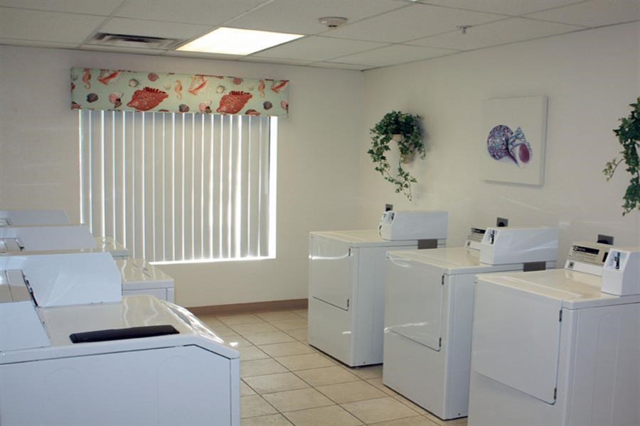 a group of white washing machines in a room