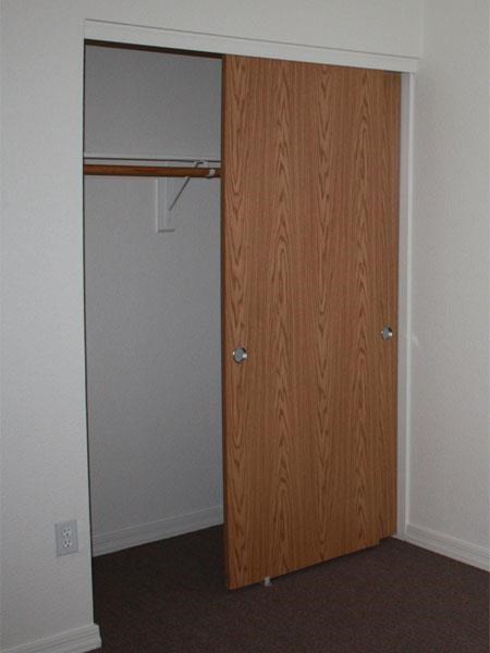 a closet with a wooden door in a room