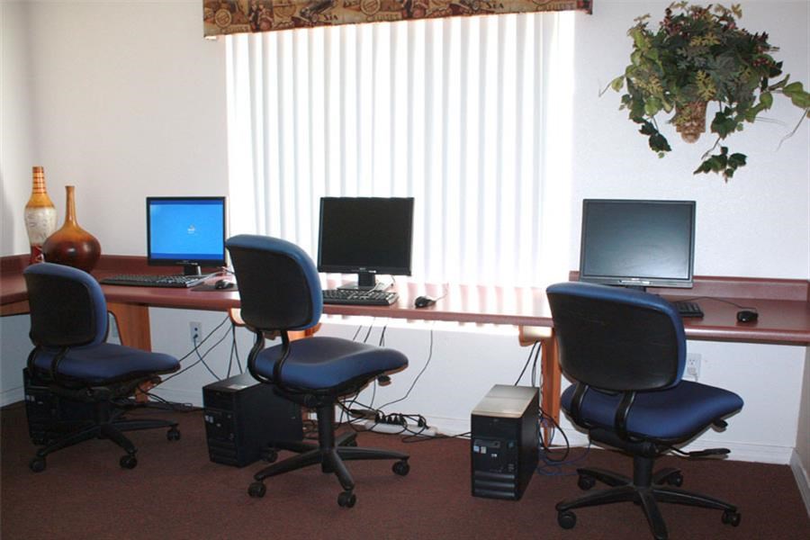a office with two desks with computers and chairs