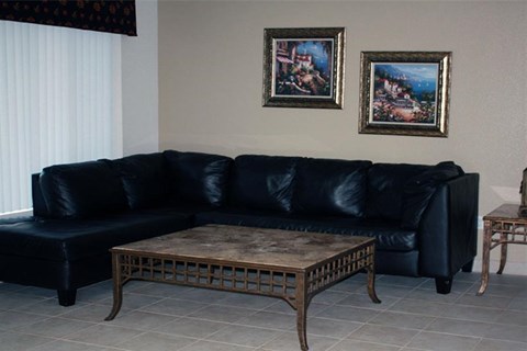 a living room with a black couch and a coffee table