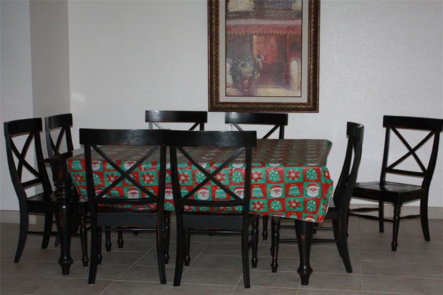 a dining table and chairs with a painting on the wall