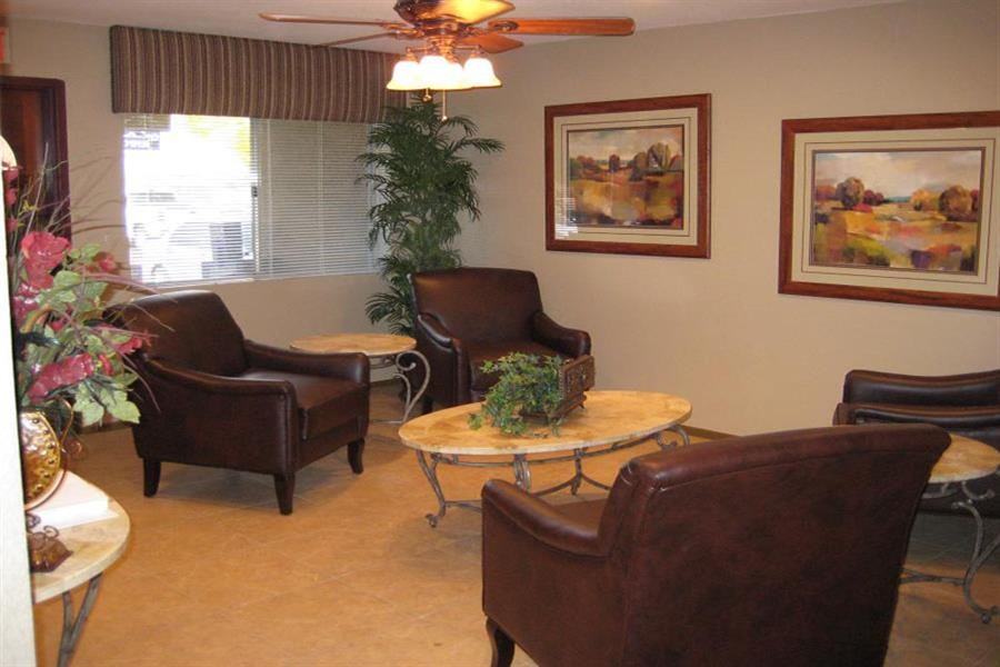 a living room with leather chairs and a table