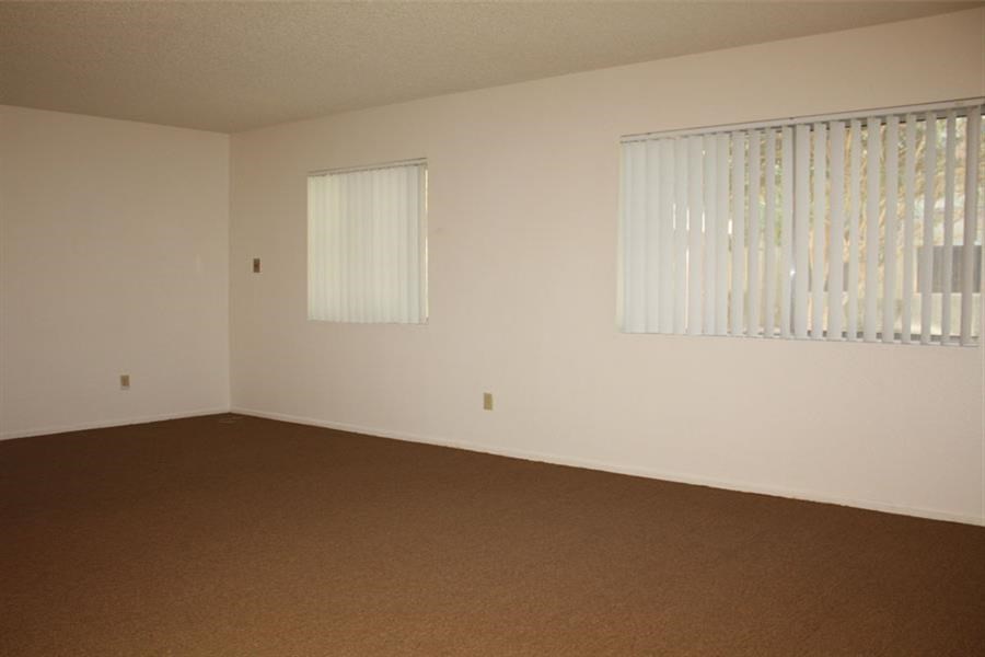 an empty room with white walls and a window