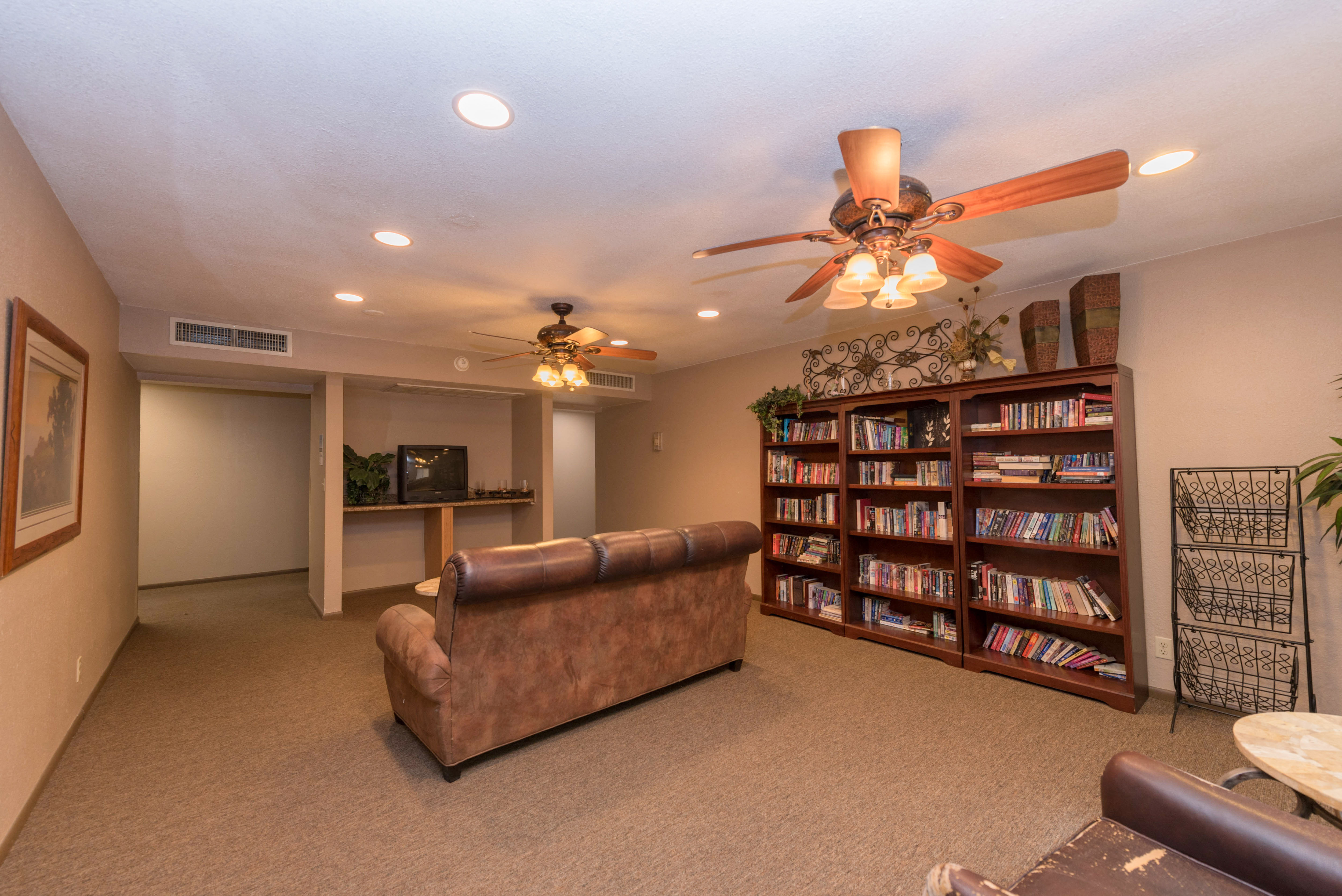 a living room with a couch and a book shelf