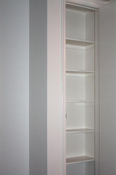 a white closet with white shelves and