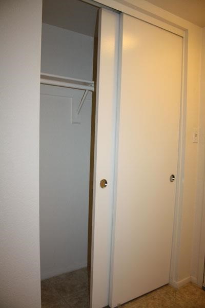 a white closet door and a white door in a room