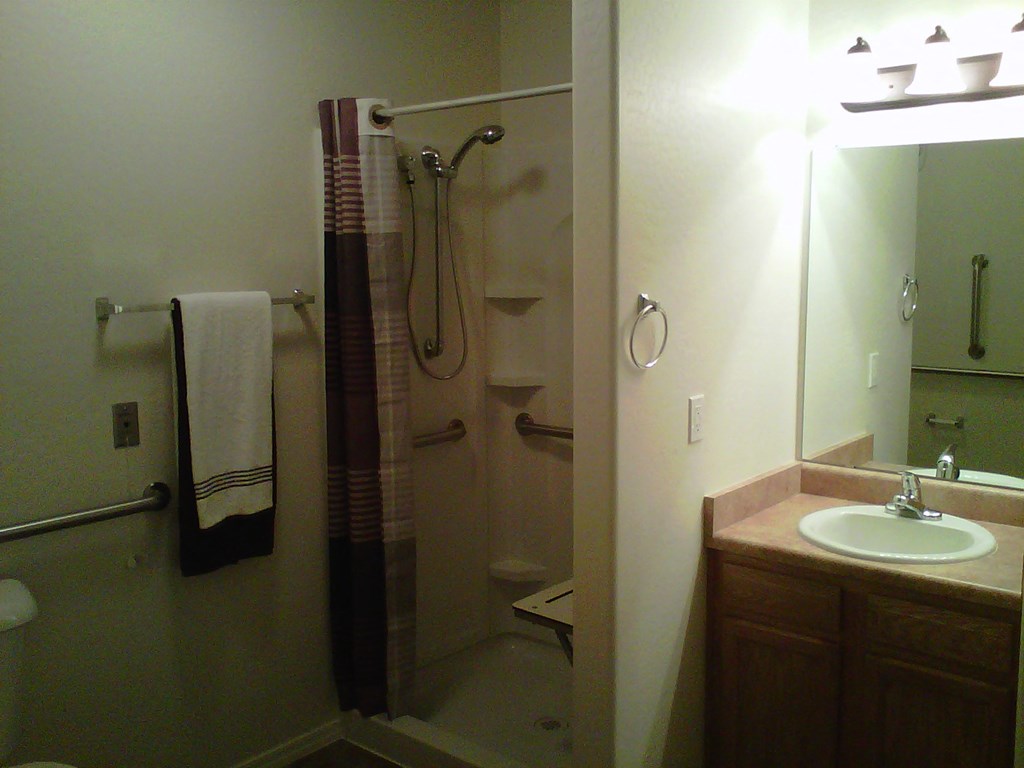 a small bathroom with a shower and a sink