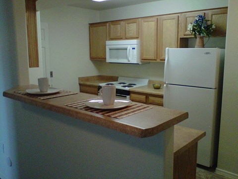 a kitchen with a counter and a refrigerator