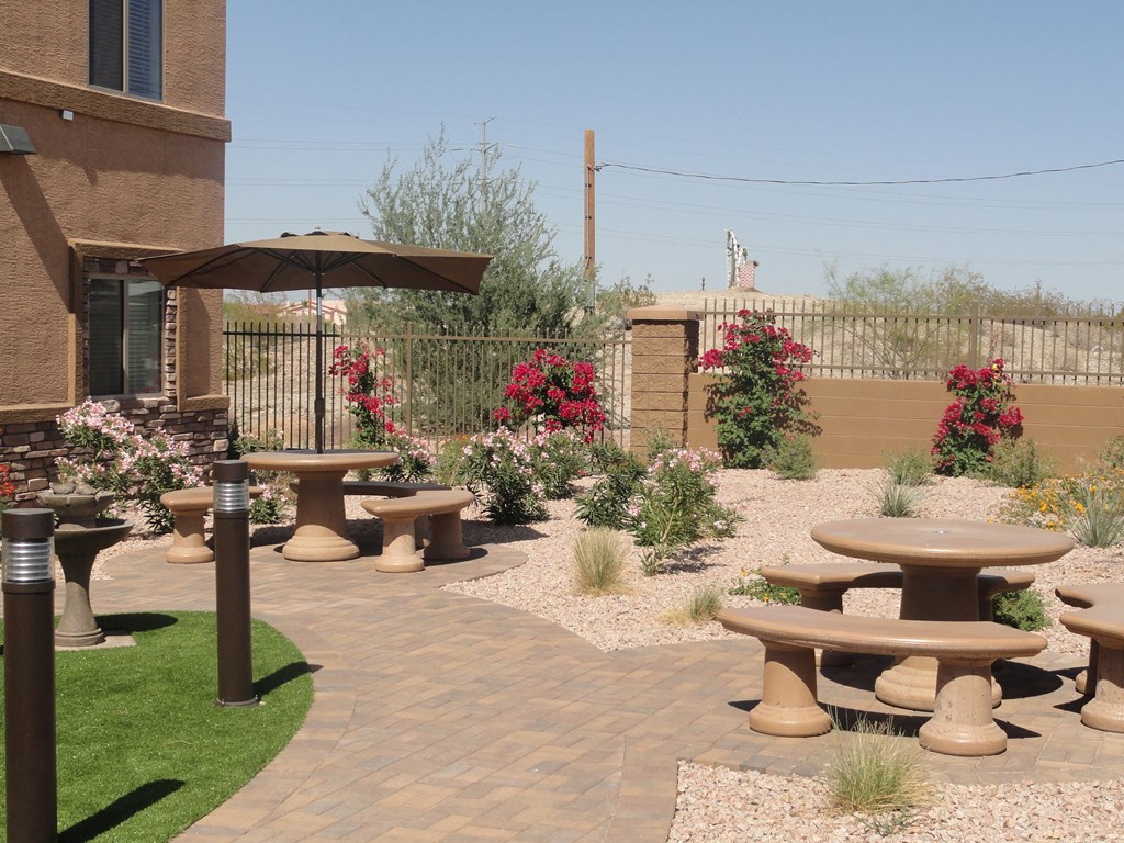 a seating area with benches and tables in a courtyard