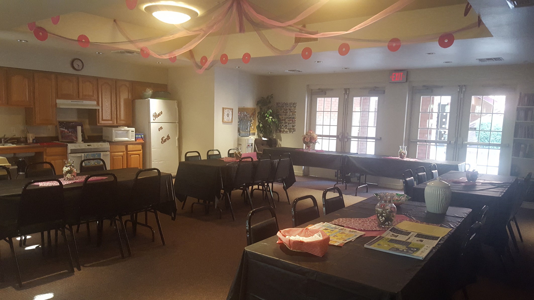 a dining room with tables and chairs and a kitchen