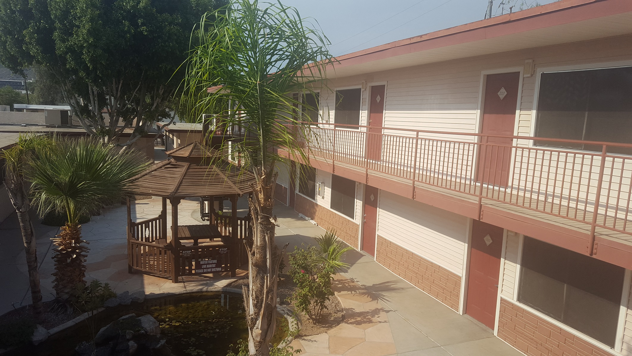 the courtyard of a building with a gazebo and a balcony