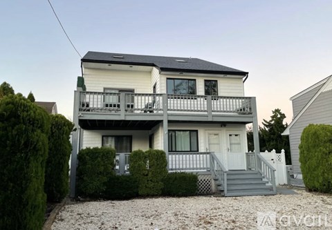 A two-story house with a balcony on the second floor.