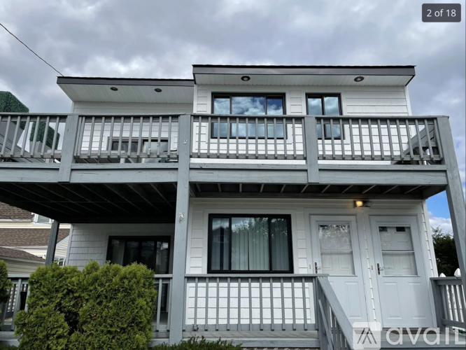 A two-story house with a balcony on the second floor.