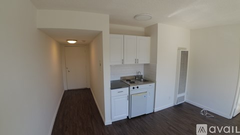 A kitchen area with white cabinets and a countertop.