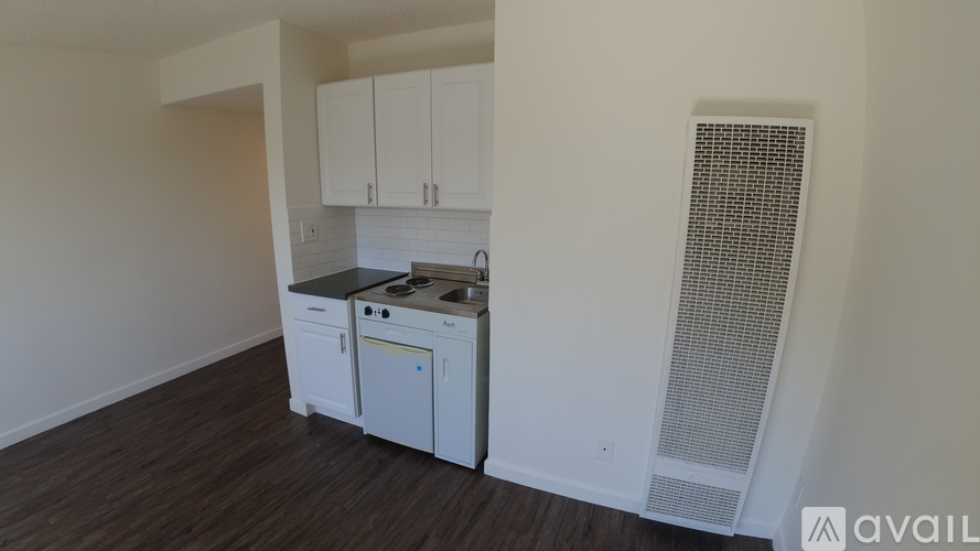 A kitchen area with a stove, oven, and cabinets.