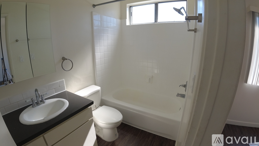 A bathroom with a sink, toilet and bathtub.