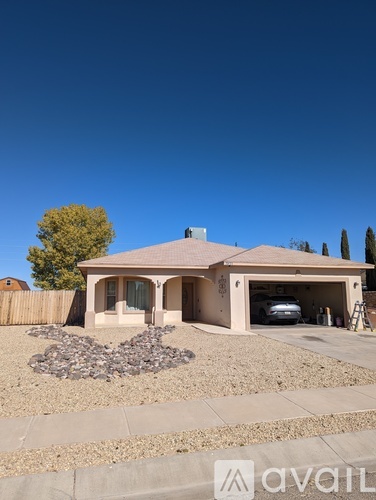 A house with a garage and a driveway in front.