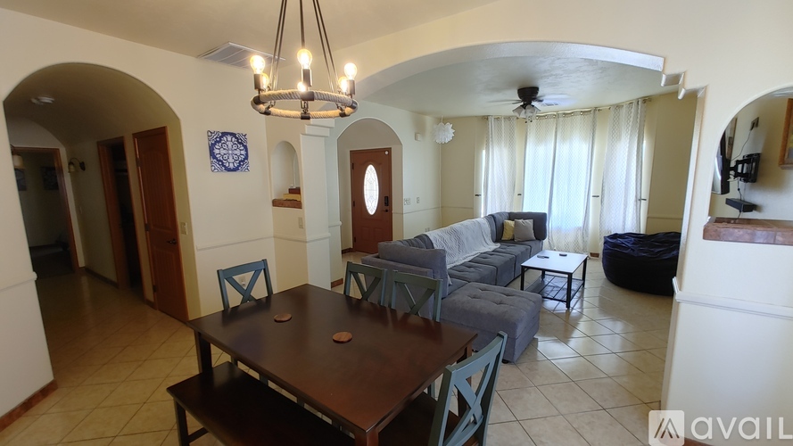 A living room with a dining table and chairs.