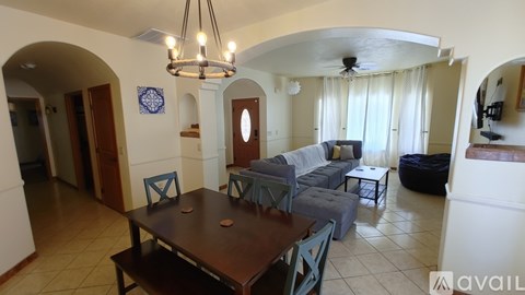 A living room with a dining table and chairs.