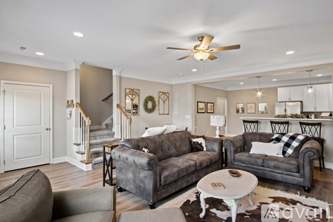 A living room with a grey couch and a white coffee table.
