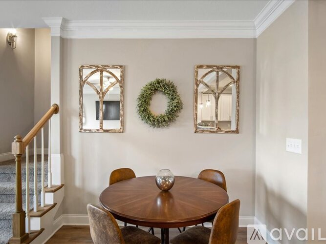 A dining room with a wooden table and chairs.