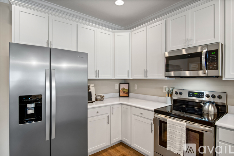 A kitchen with white cabinets and stainless steel appliances.