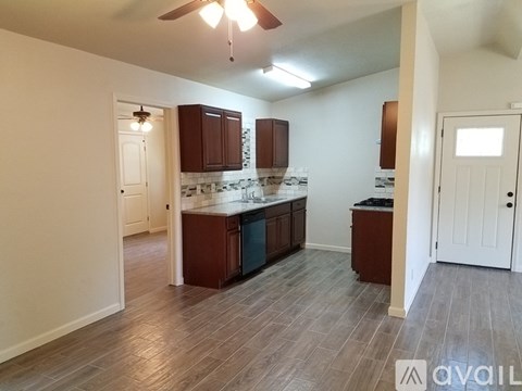 A kitchen with wooden cabinets and a central island.