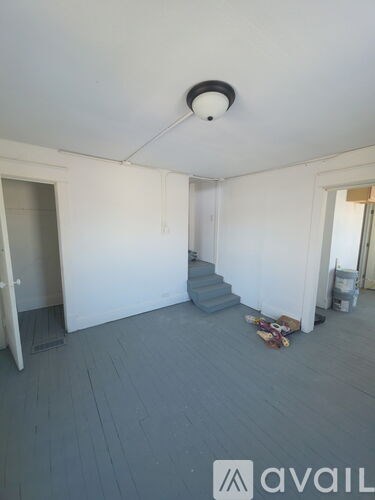 A room with a grey floor and white walls.