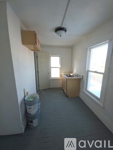 A room with a window and a cabinet is available for rent.