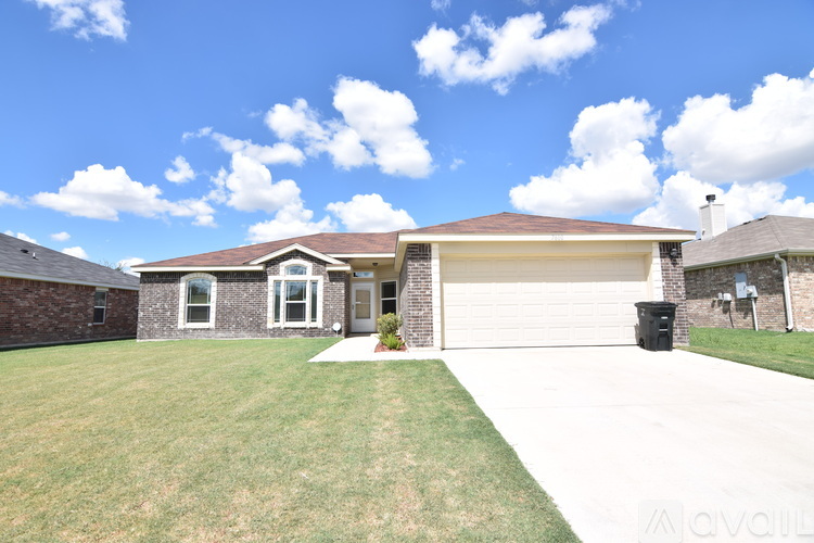 A house with a brown roof and a white garage door is for sale.