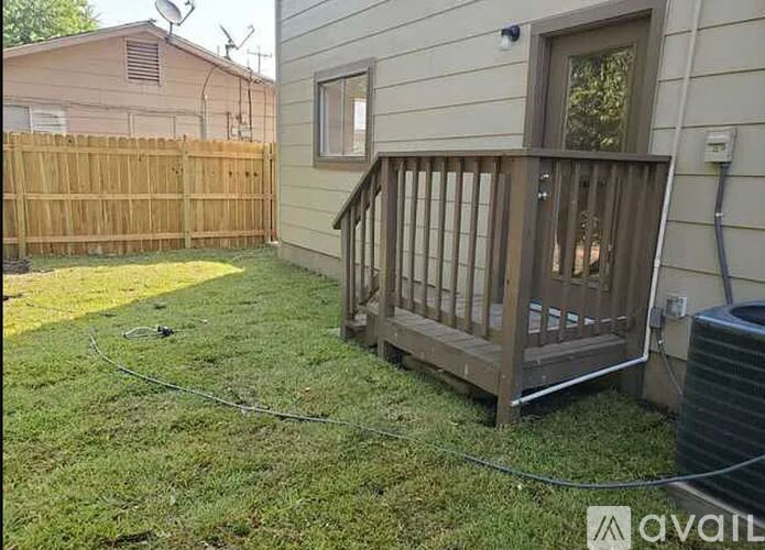 A wooden deck is attached to a house.