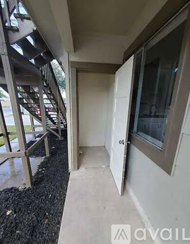 A white door is open to a hallway.