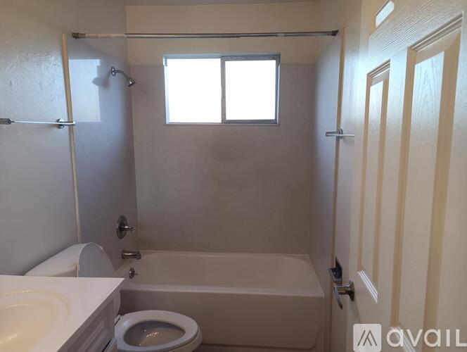 A small bathroom with a toilet, sink, and bathtub.