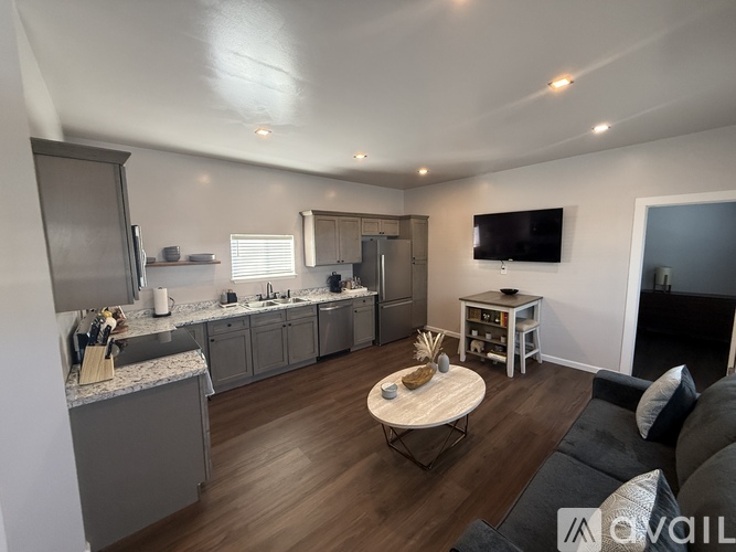 A modern kitchen with a breakfast table and a couch.