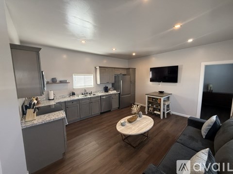 A modern kitchen with a breakfast table and a couch.