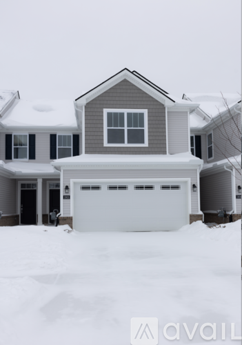 A house with a garage covered in snow.