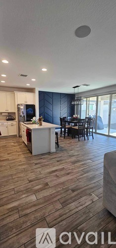 A modern kitchen with a dining area and a living room.