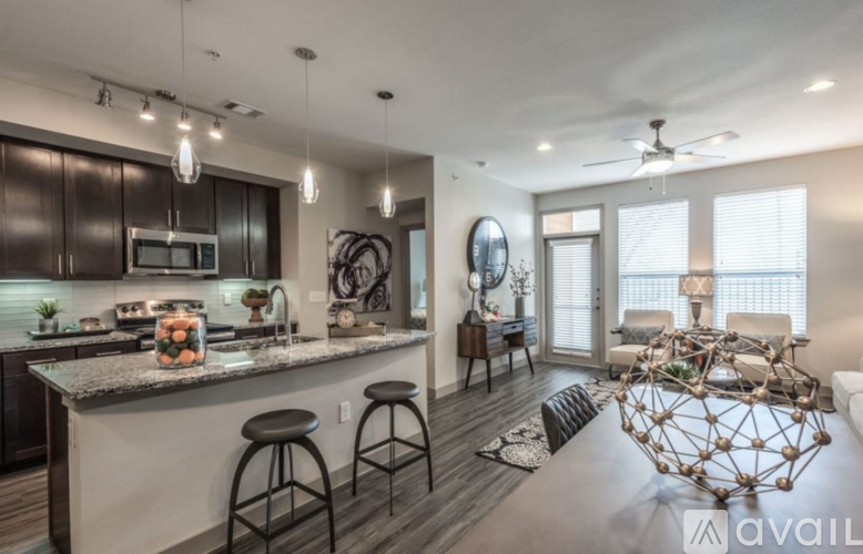 A modern kitchen with dark wood cabinets and a white island.