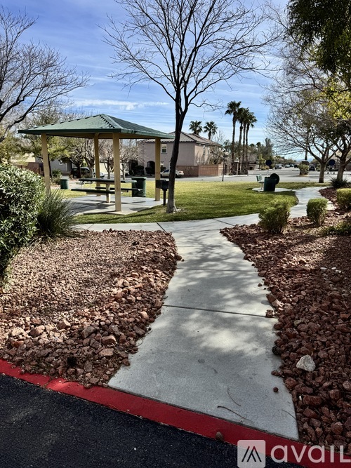 A park with a gazebo and a red and white striped curb.