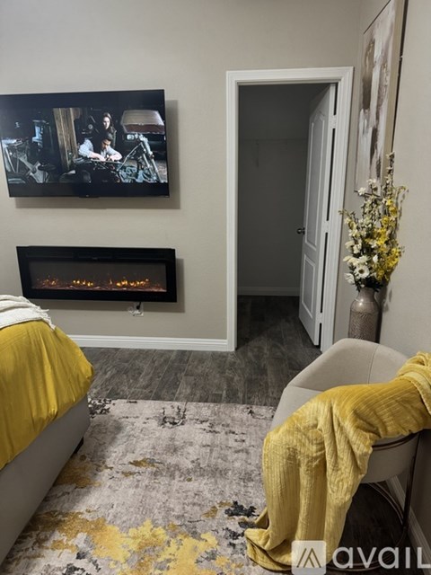 A living room with a fireplace and a painting on the wall.